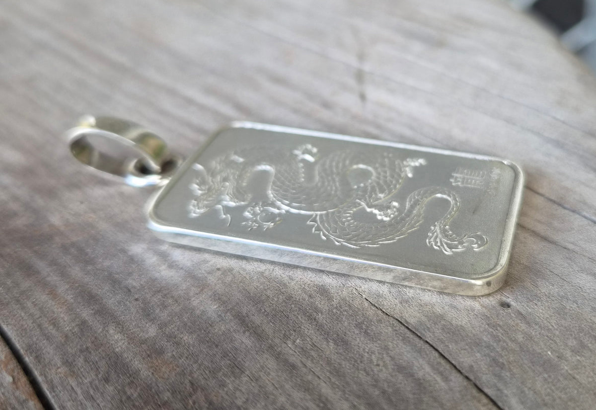 Dragon pendant,1 troy onze bullion bar.99.9 percent silver.Perth mint Australia