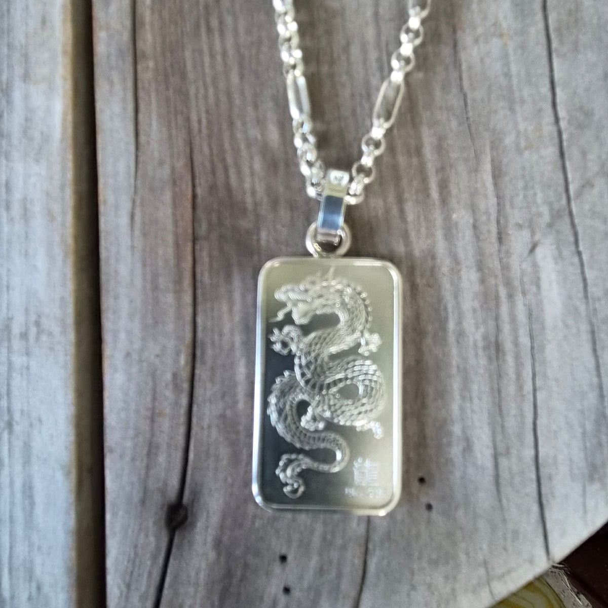 Dragon pendant,1 troy onze bullion bar.99.9 percent silver.Perth mint Australia
